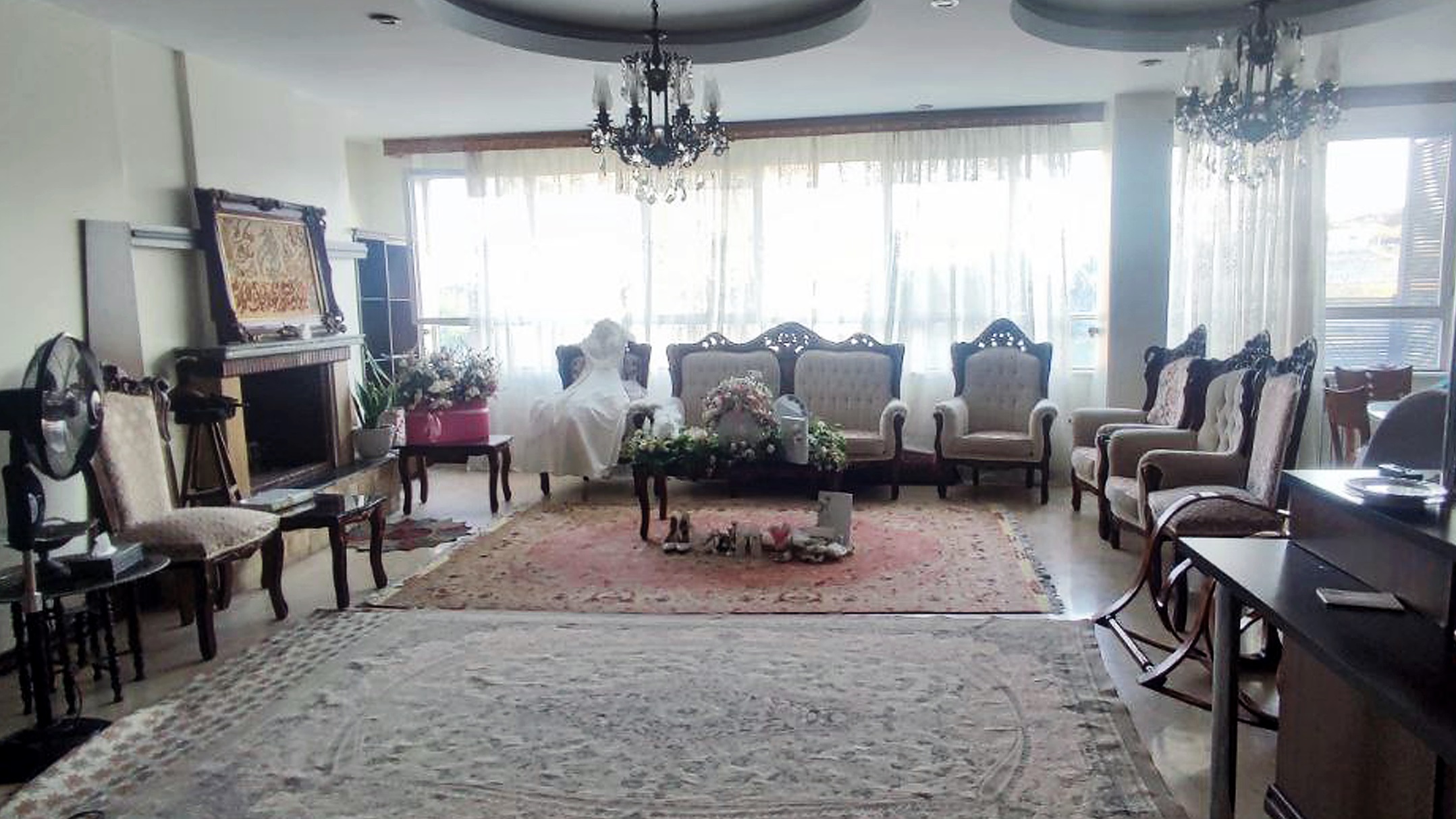 A wedding dress displayed in a living room.