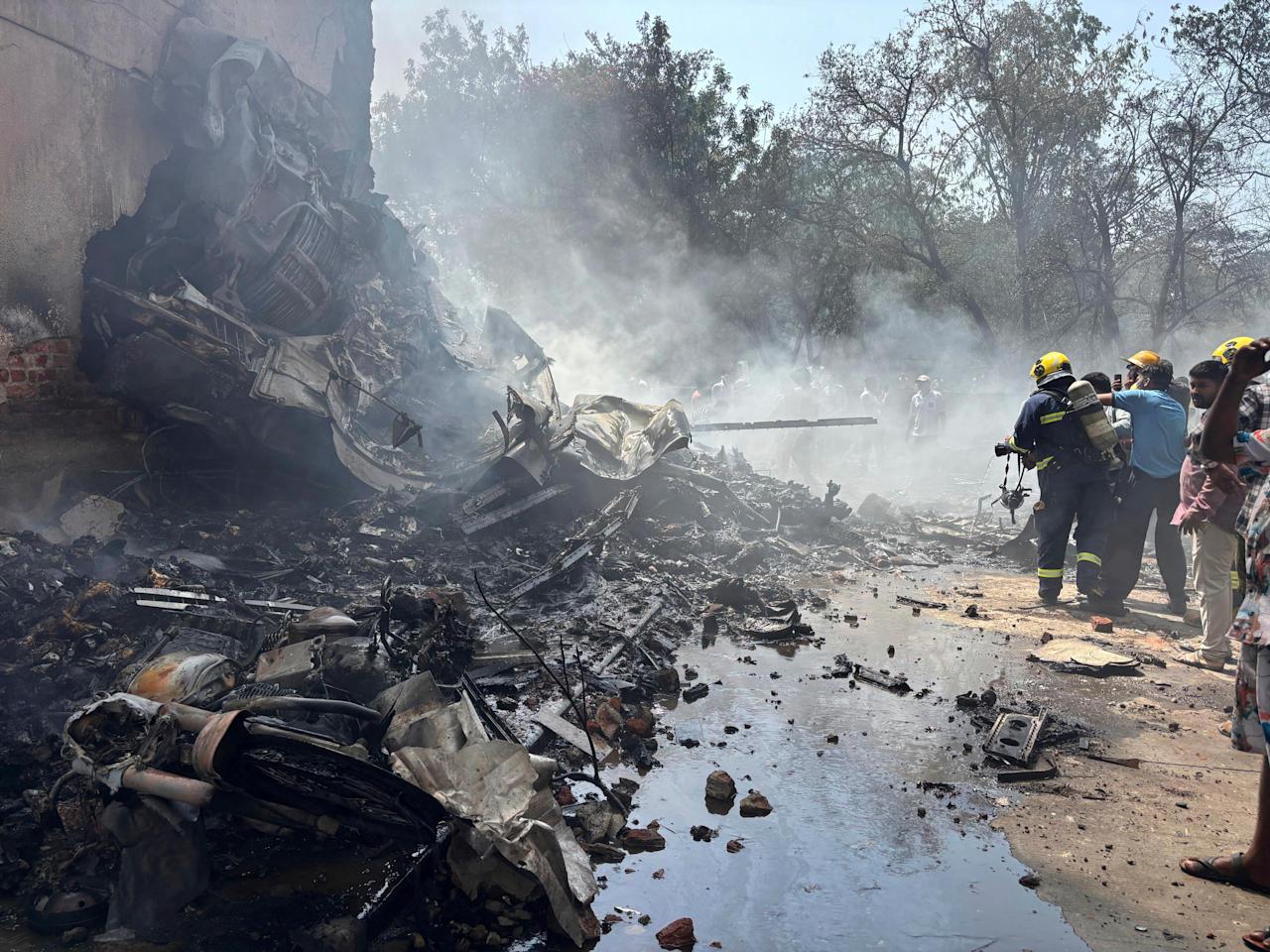 Firefighters work at the site of an airplane that crashed in India's northwestern city of Ahmedabad in Gujarat state, Thursday, June12, 2025. (AP Photo/Ajit Solanki)