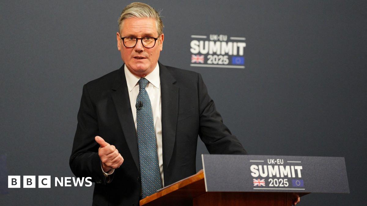 Sir Keir Starmer gives a press conference from behind a podium reading "UK-EU summit 2025".