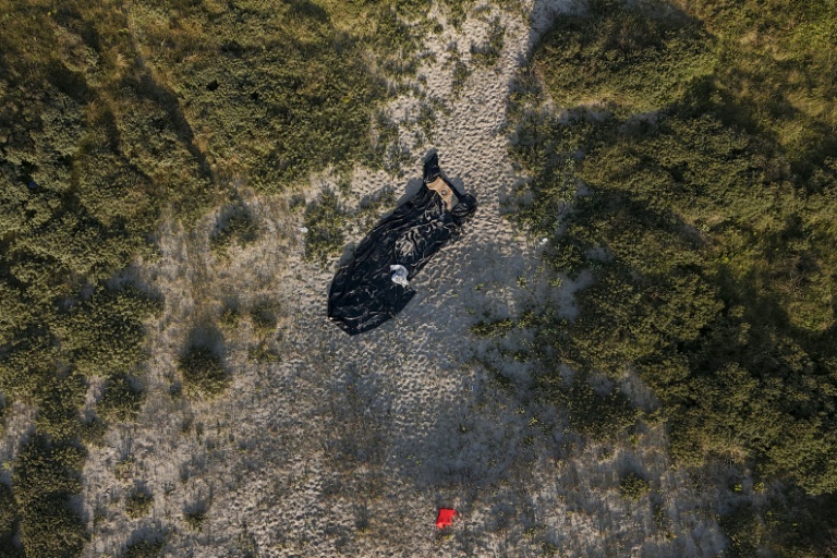 A deflated dinghy on a French beach (Sameer Al-DOUMY)