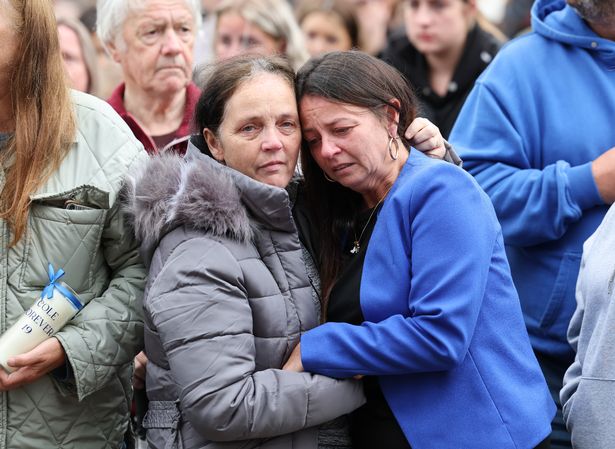 Cole Cooper's mother Wendy Stewart, (right), is comforted at the vigil