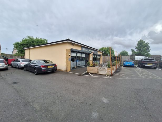A wide shot of an Italian restaurant which is one-storey and is at a retail area 