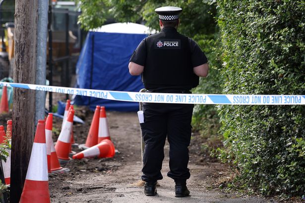 Police taped off a path off Green Lane, Horwich