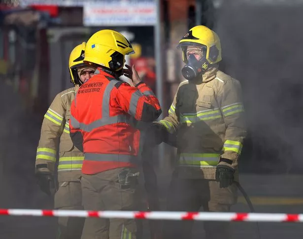 Firefighters donned breathing apparatus in the foul-smelling smoke