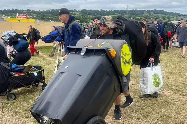 Arriving at Glastonbury with a wheelie bin full of camping equipment. Photo: BBC News