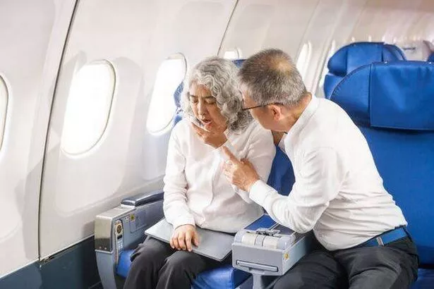 A couple experiences air sickness during a flight