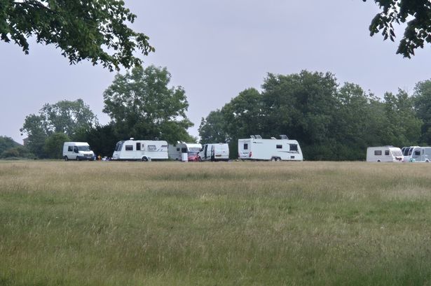 An encampment of caravans on the Downs in June