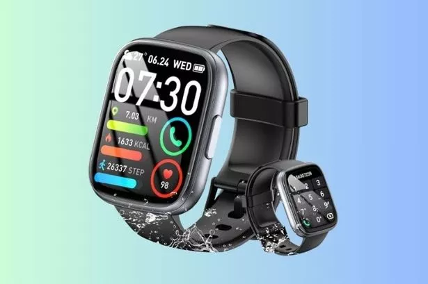 The black smart watch in front of a colourful background