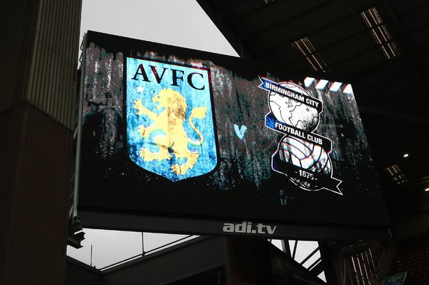 An LED board inside Villa Park showing the Aston Villa and Birmingham City crests
