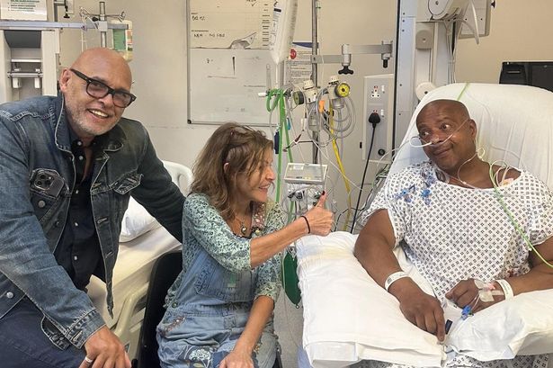 Lionel Duke in hospital with Garry Christian and the band's manager Emma Roberts