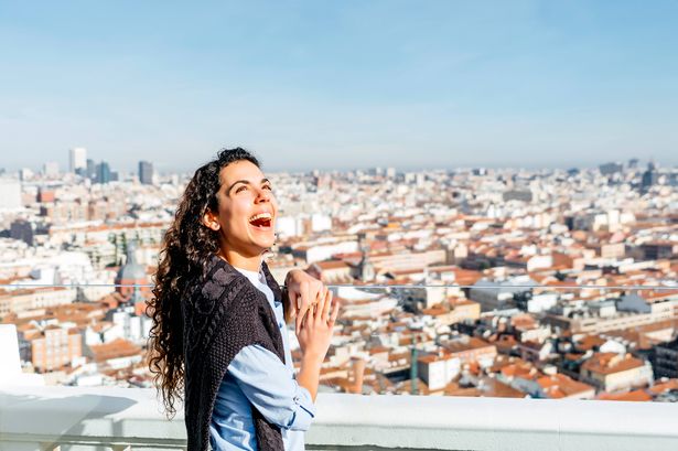 Beautiful woman and the city of Madrid Spain in the background.