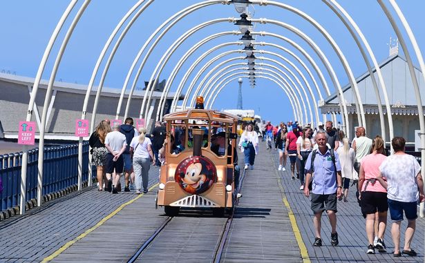 Crowds enjoying the heatwave sunshine on Southport Pier in past summers - it's hoped the landmark will reopen soon