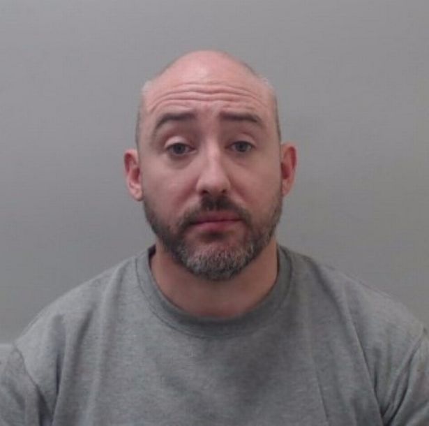 Stephen McCourt in grey sweat shirt with greying hair, bald on top and beard