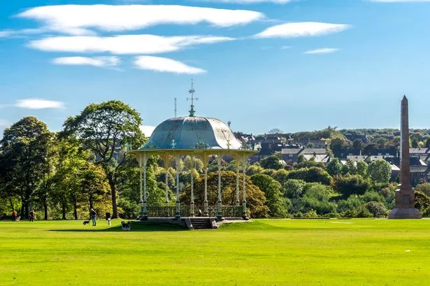A large lawn with a scenic arbour and McGrigor obelisk in Duthie Park, Aberdeen, Scotland