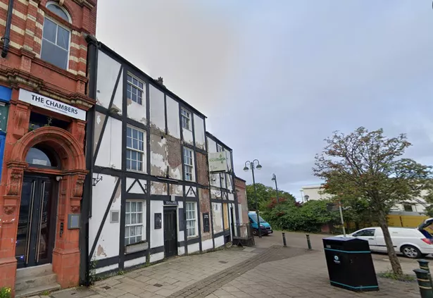 A once beautiful mock Tudor building, once home to The Crowns inn, and later the Oldham Foodbank.