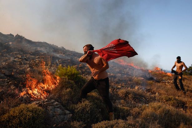 Residents try to contain a wildfire outside the town of Chios island in Greece, June 22, 2025. (Photo by Dimitris Tosidis / SOOC via AFP) (Photo by DIMITRIS TOSIDIS/SOOC/AFP via Getty Images)          
