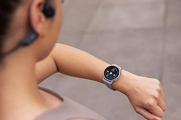 Woman changing music on the watch.