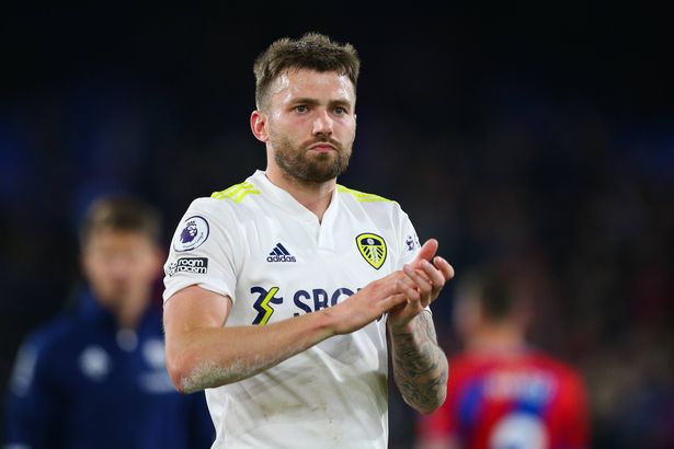 Stuart Dallas claps fans in a Leeds United shirt