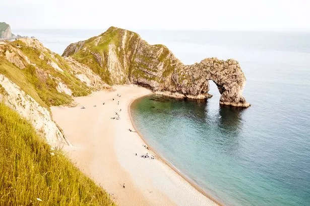 Lulworth Cove is the most famous beach on the Jurassic coast and its durdle door - a magnificent natural limestone arch formed by waves eroding a hole into the rock - is the scene of many a postcard