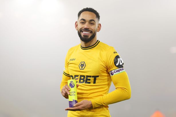 Matheus Cunha poses with a Premier League Man of the Match award.