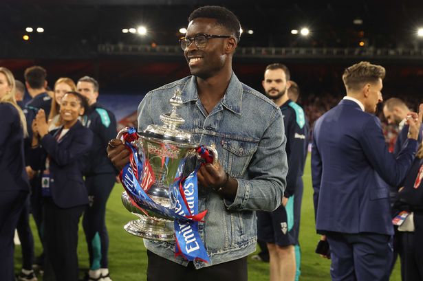 Marc Guehi of Crystal Palace holds aloft the Emirates FA Cup Trophy in celebration after the Premier League match between Crystal Palace FC and Wolverhampton Wanderers FC at Selhurst Park