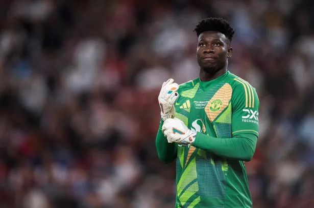 Andre Onana adjusts his gloves during the Europa League final.