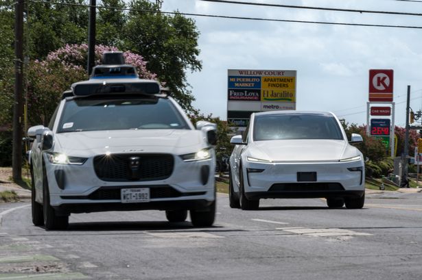 A Waymo autonomous taxi, left, and a vehicle Tesla is using for robotaxi testing purposes in Austin, Texas, US