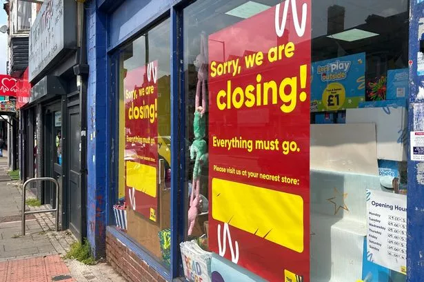 Photo shows closing down sign in window