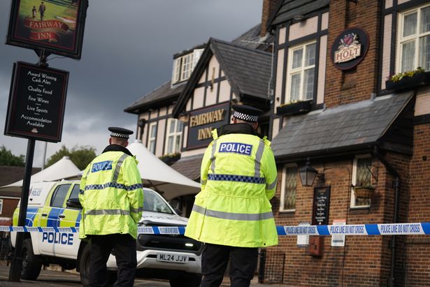 Officers outside the pub which was also cordoned off