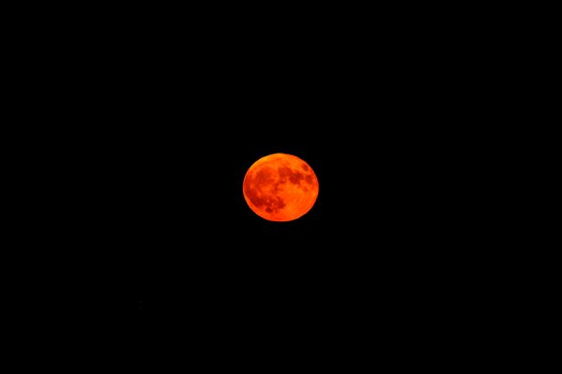 A Strawberry Moon, sometimes referred to as a Rose Moon, can have reddish-pink hues