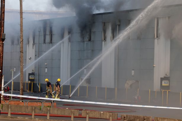 Firefighters battle with a fire at Storage World in Middleton for the second day