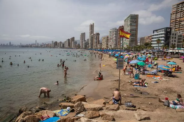 Bathers enjoying the beach in Benidorm