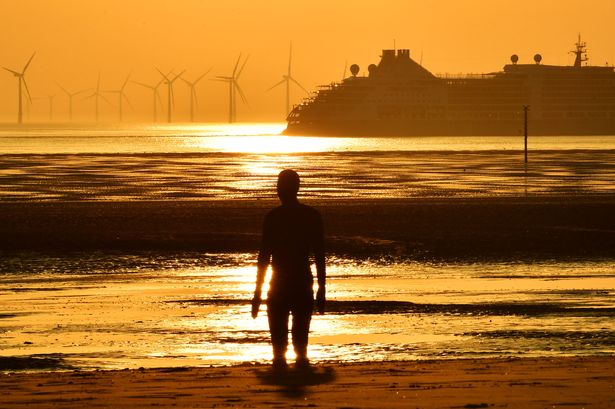 Heatwave weather as sunsets on Crosby Beach