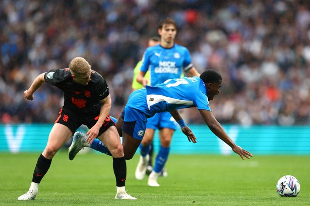 Kwame Poku is fouled by Alex Cochrane.