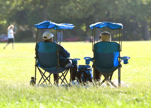 People enjoying the warm weather in Sefton Park