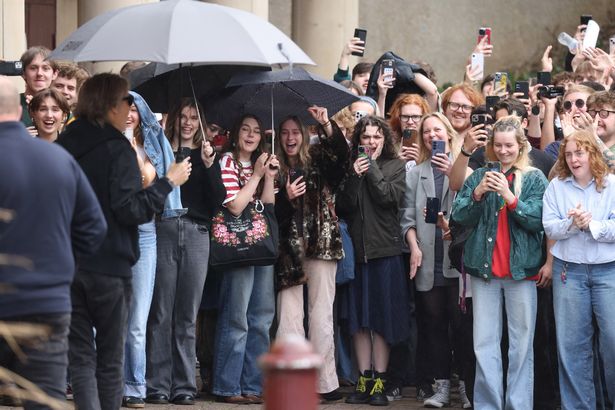 Sir Paul McCartney posed for photographs as he arrived at LIPA 