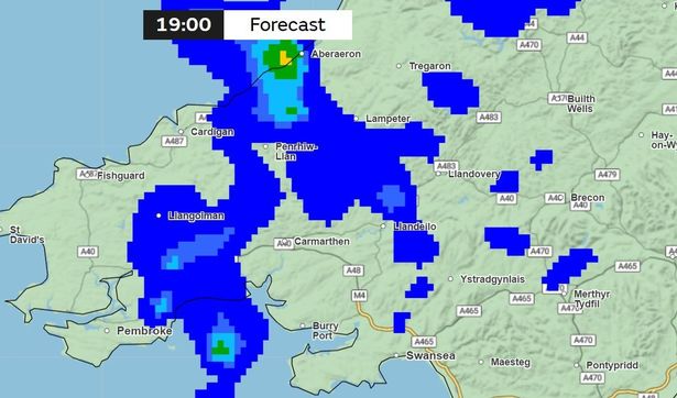 A weather map with large blue patches over parts to indicate rainfall