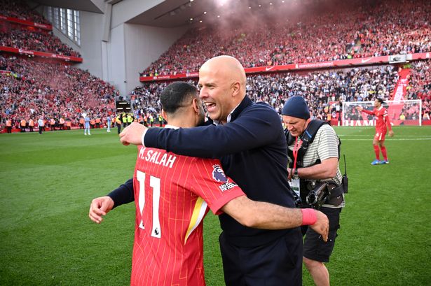 Arne Slot, Manger of Liverpool, embraces Mohamed Salah of Liverpool, as they celebrate the teams victory and confirmation of winning the Premier League title after the Premier League match between Liverpool FC and Tottenham Hotspur FC at Anfield on April 27, 2025 in Liverpool, England