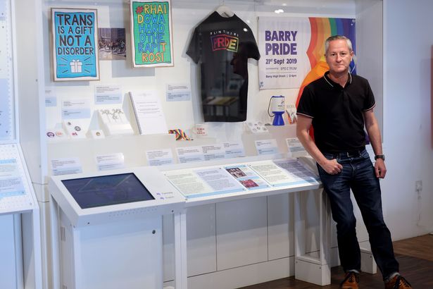 Mark standing beside part of the collection at St Fagans museum in Cardiff