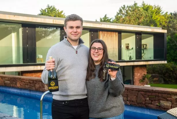 Omaze winners Lauren Keene & Ryan Mitchell outside their £3m home
