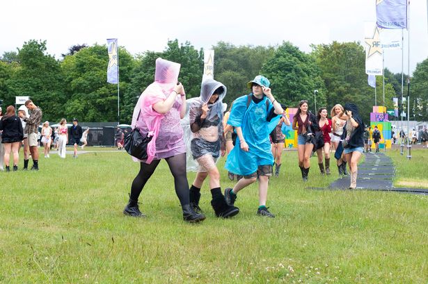 Parklife goers walking into the first day of the festival while battling the elements