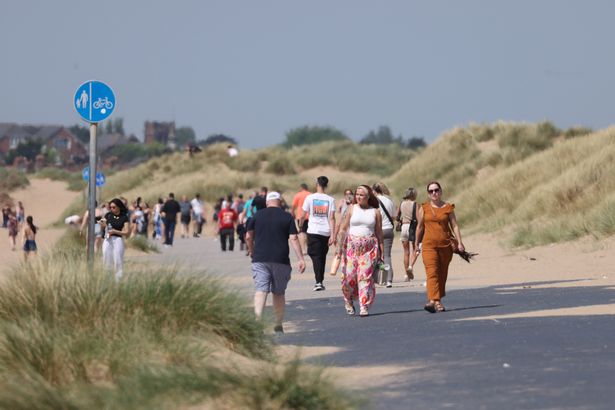 People enjoy the hot weather on Crosby beach