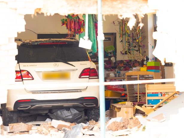 The white Mercedes after it crashed into the school