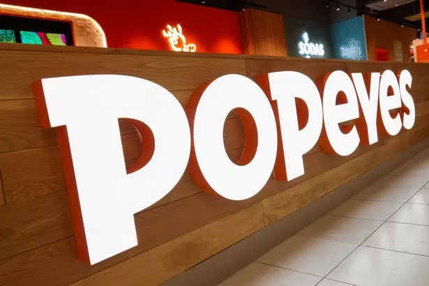 The bright Popeyes logo at the counter of the chain's first airport restaurant which has opened at BHX 