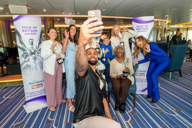People posing with trophies