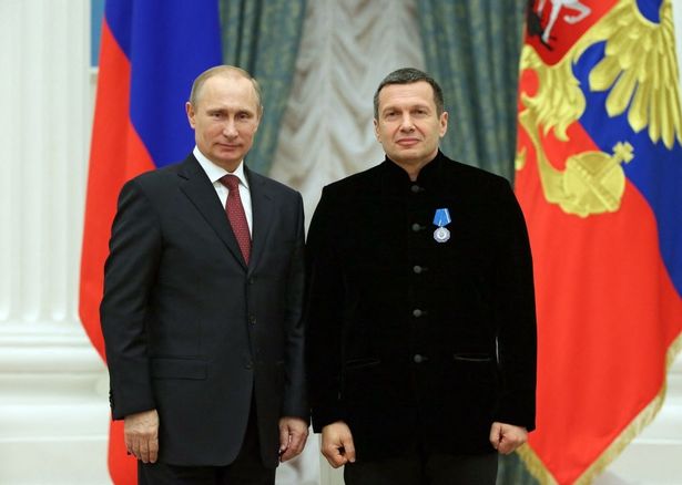 Russian President Vladimir Putin poses with TV anchor Vladimir Solovyov 