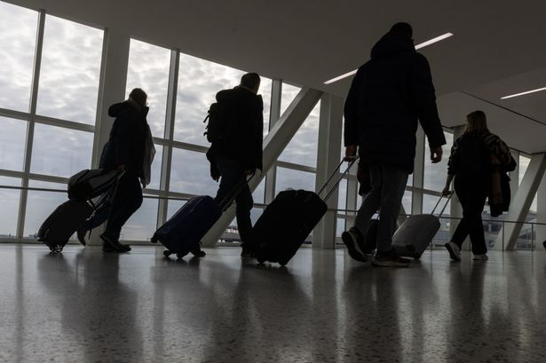 Travelers walk with their luggage at John F. Kennedy International Airport