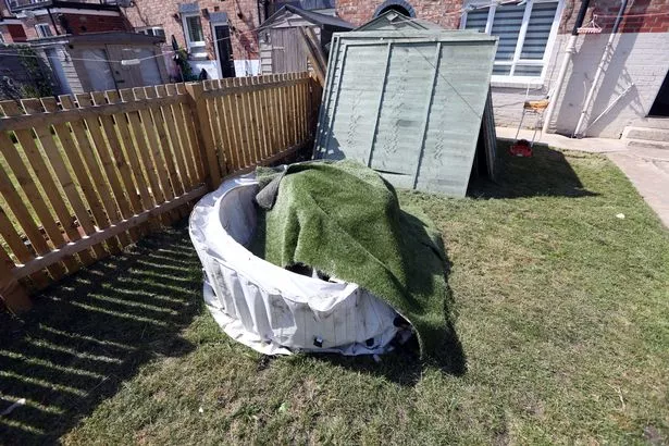 Melanie's hot tub, which she says contractors dragged across the garden and damaged