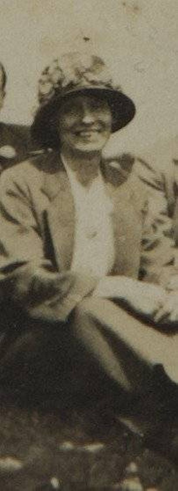 An old picture of a woman wearing a hat