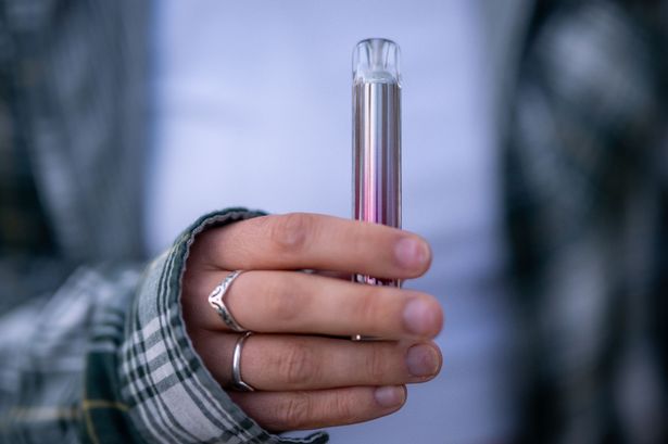 A person holding a vape
